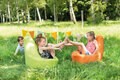 Kinder sitzen im Freien auf einem Sitzsack