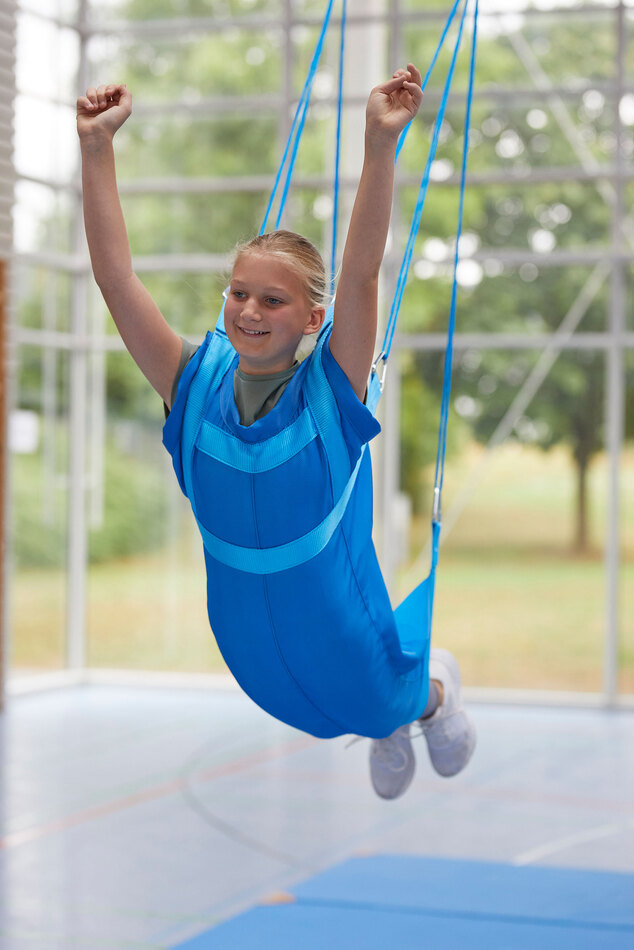 Flugschaukel mit Kind in einer Turnhalle